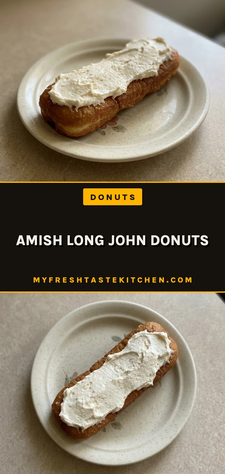 Bird's-eye view of two oblong donuts topped with white icing and vanilla flecks on a dark surface.