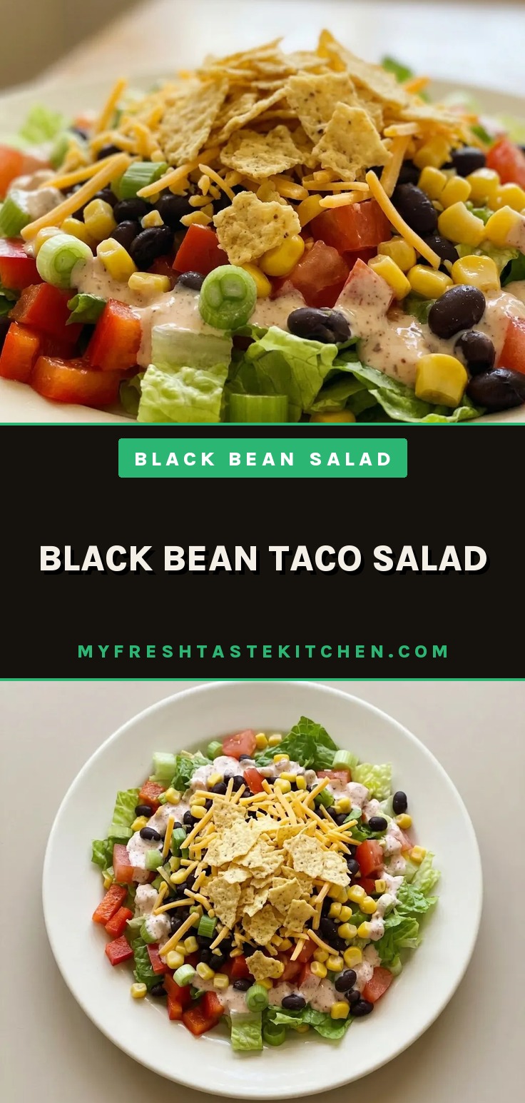 Overhead shot of a taco salad with black beans, corn, romaine, diced tomatoes, red bell pepper, shredded cheddar, tortilla chips, salsa, sour cream, and lime wedges.
