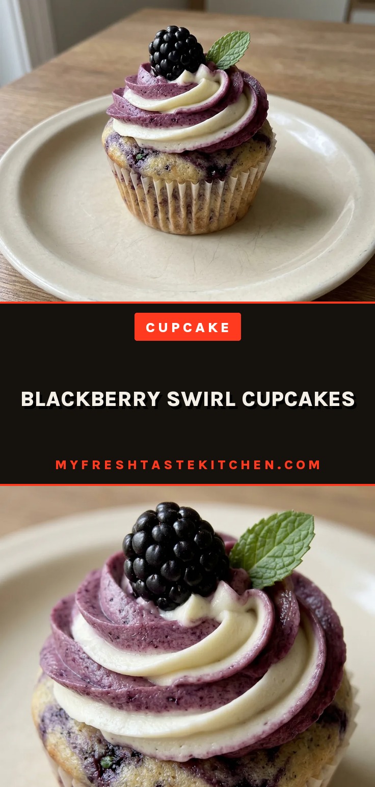 Overhead shot of a blackberry swirl cupcake topped with cream cheese frosting and a whole blackberry.