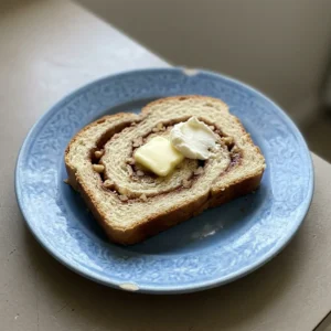 Bird's-eye view of a loaf of cinnamon bread sliced, revealing a spiral of brown sugar and cinnamon.