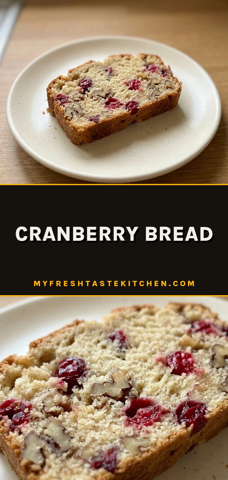 Bird's-eye view of a round cranberry bread loaf studded with red berries and a glossy top.