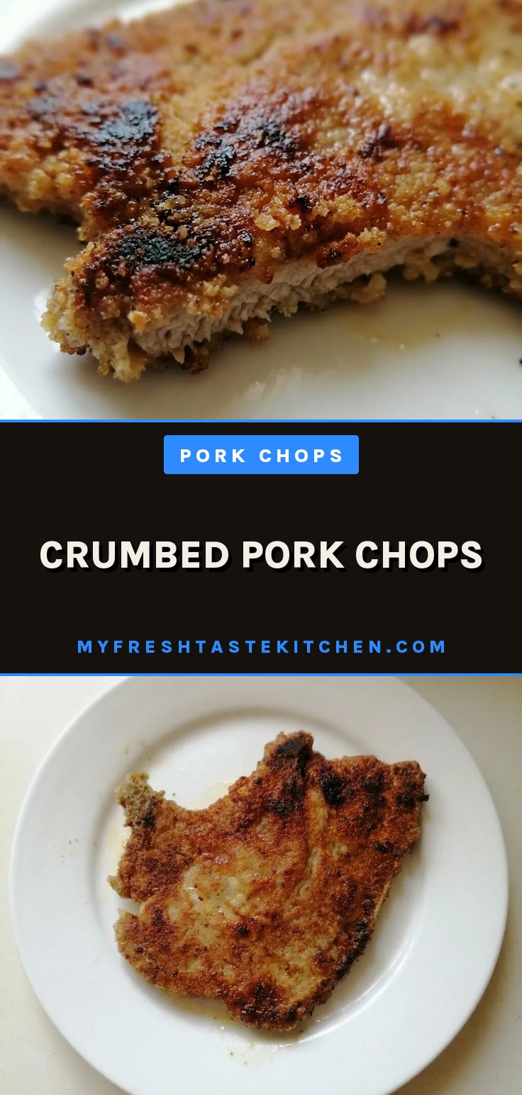 Overhead shot of two breaded pork chops with golden brown crust and herb flecks.