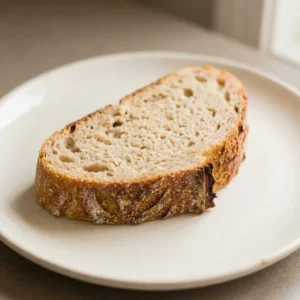 Overhead shot of a round loaf with a scored top, visible salt crystals on the crust.