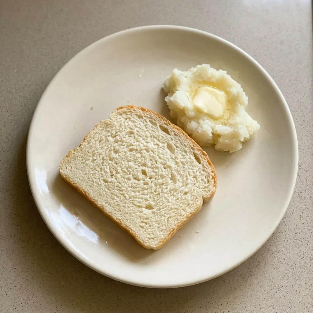 A plate of sliced bread with a rustic, golden-brown crust and airy interior.