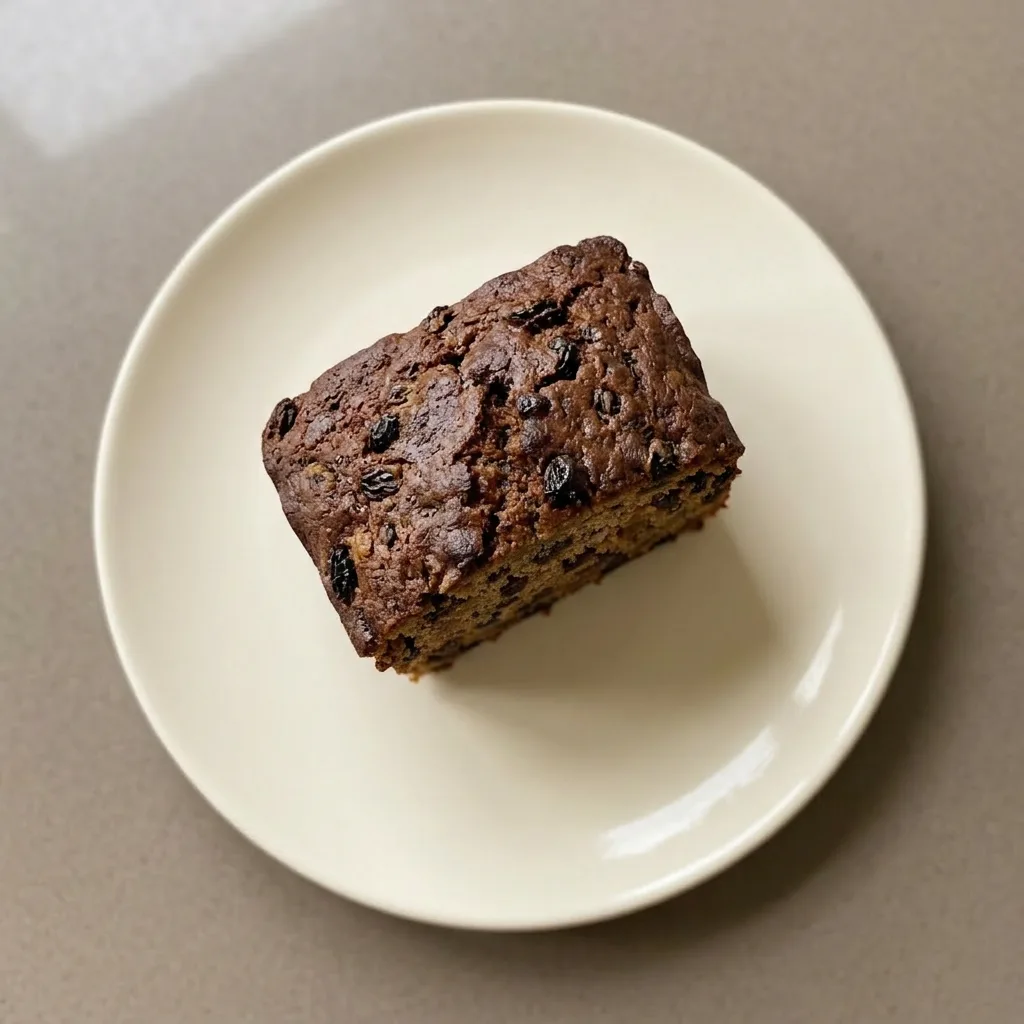 A plate of sliced tea loaf, each piece studded with dried fruit.