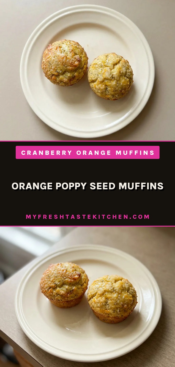 Top-down look at a golden muffin with a cracked dome, dotted with poppy seeds and speckled orange zest.