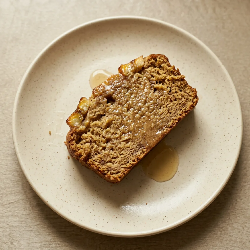 A serving of plantain bread slice topped with rum glaze and caramelized brown sugar.