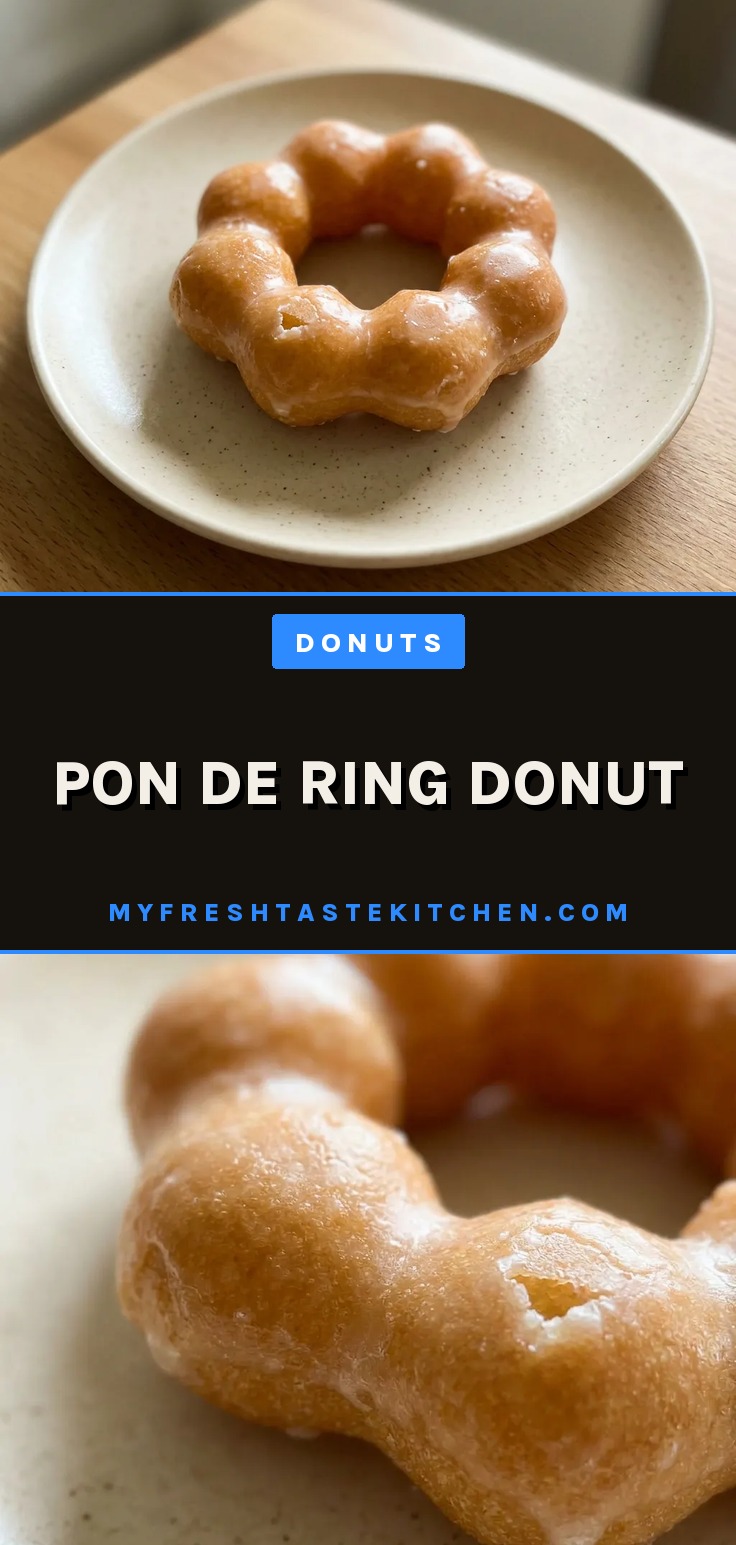Matcha pon de ring donut, a mochi donut with green glaze on a wire rack.