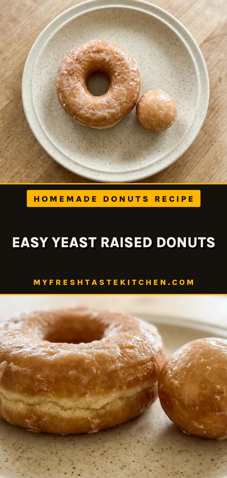 Raised donuts filled with strawberry jam and a dusting of sugar, with visible nutmeg specks.