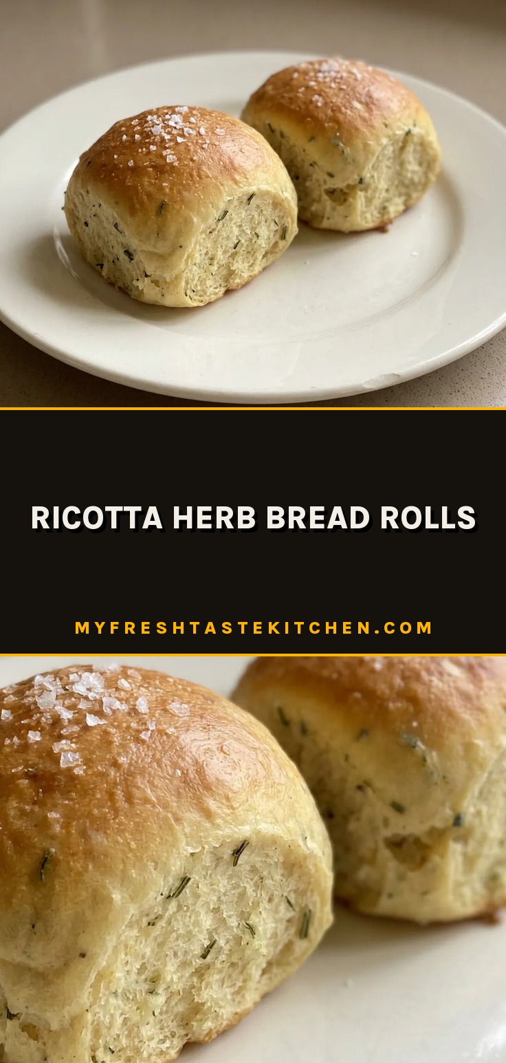 Overhead shot of round ricotta herb rolls topped with rosemary and thyme leaves, golden brown crust.