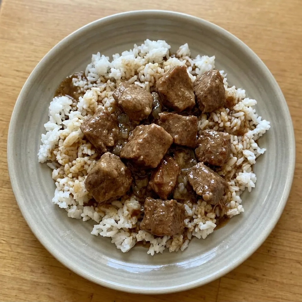 Ready to serve: a portion of beef tips and gravy, garnished with a sprinkle of fresh parsley.