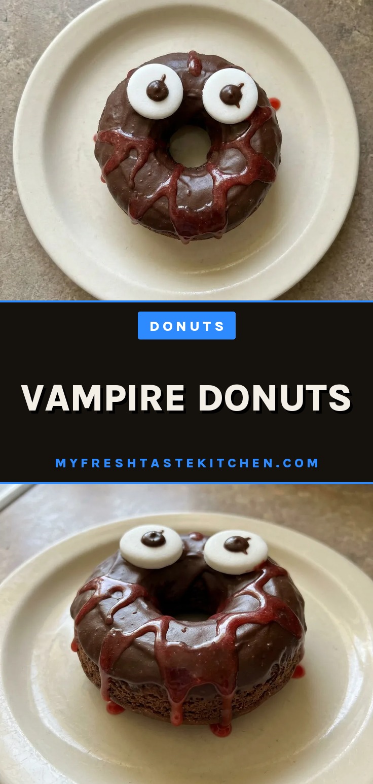 Vampire donuts with dark chocolate glaze and red food coloring drizzle on a wire rack.
