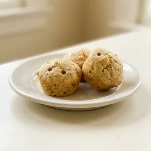 Top-down look at a muffin with apple, banana, and carrot bits, topped with cinnamon streusel.