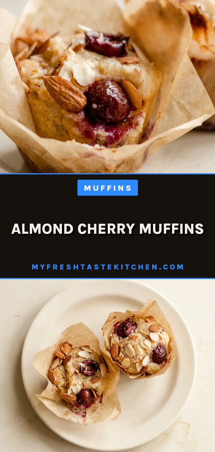 Looking down at two almond cherry muffins with visible cherry pieces and almond slivers on top, set in a white paper liner.