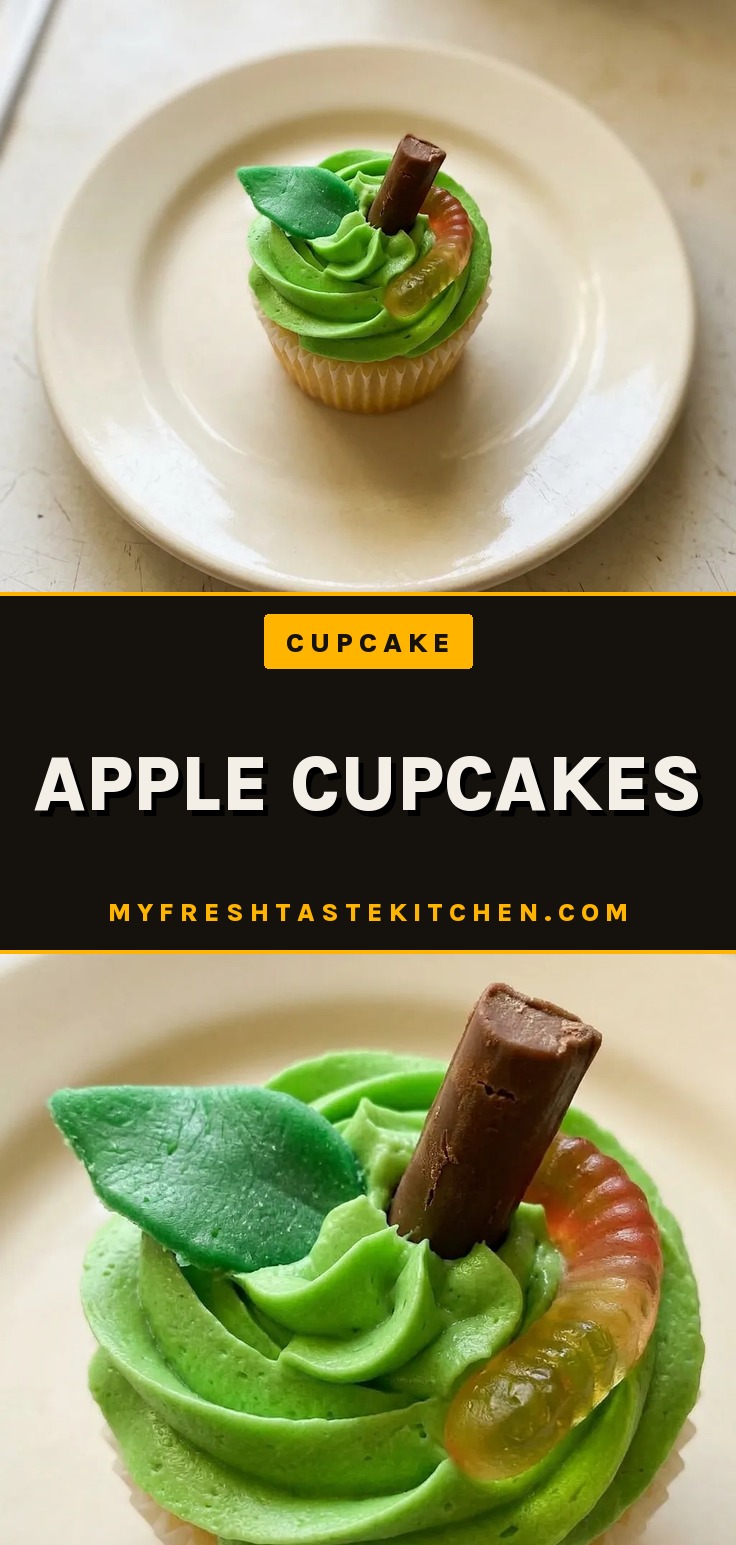 Overhead shot of a frosted apple cupcake topped with a Tootsie Roll, Airhead, and gummy worms.