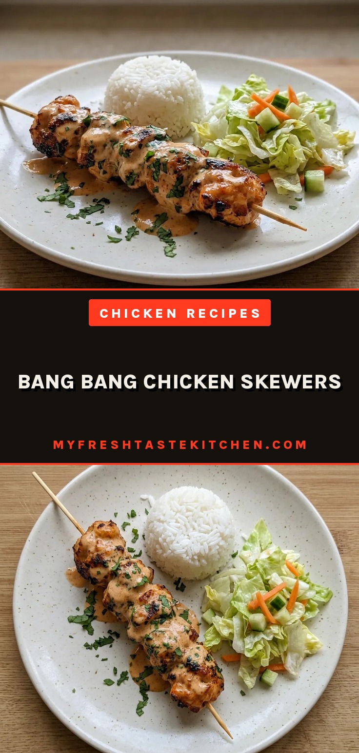 Top-down look at skewered chicken pieces drizzled with white and red sauce, garnished with lime wedges and green herbs.