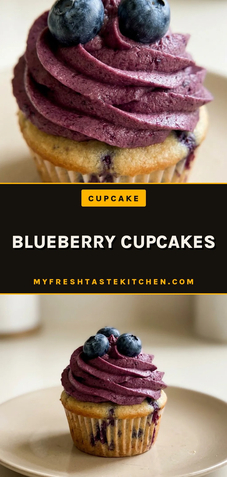 Looking down at three blueberry cupcakes on a white plate, each topped with vanilla buttercream and a single blueberry.