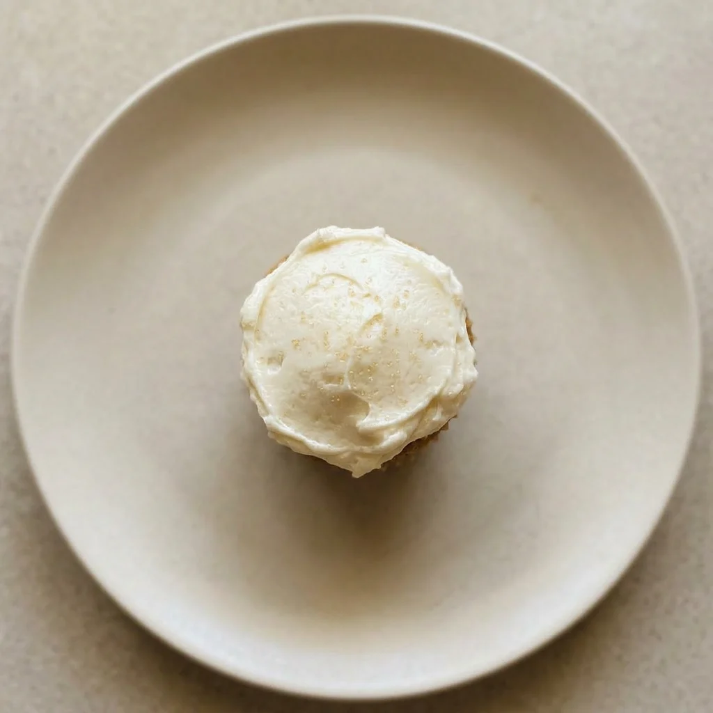 Ready to serve: a brown sugar cupcake with a generous buttercream frosting swirl.