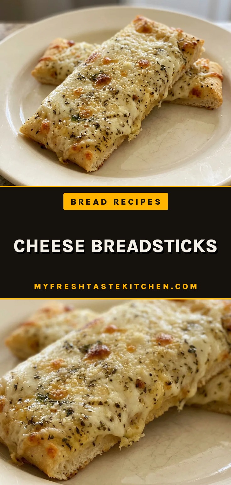 Top-down look at cheese breadsticks arranged in a row, topped with melted mozzarella, Parmesan, basil, and oregano.