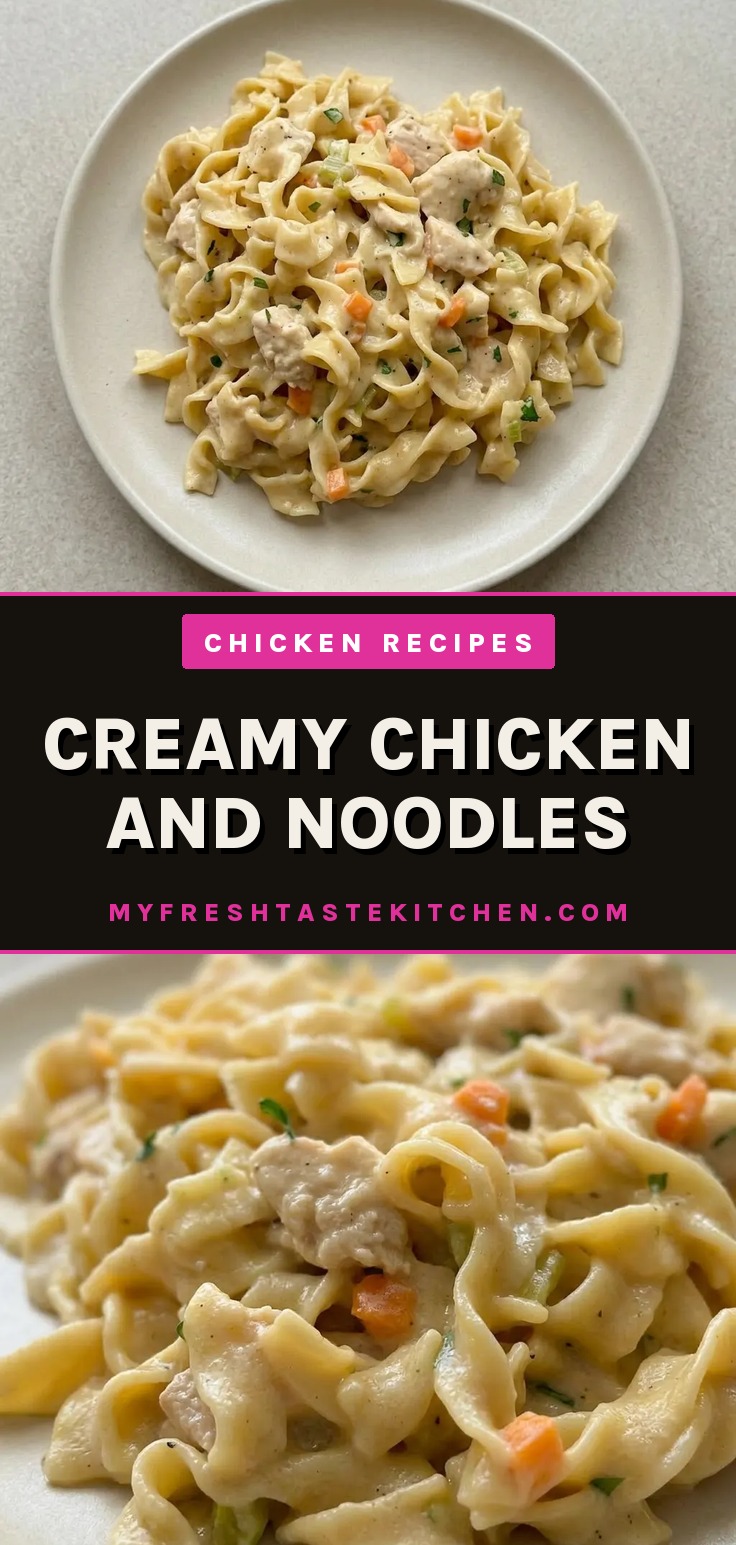 Looking down at creamy chicken and egg noodles with chunks of chicken, carrots, celery, and onion in a light sauce.