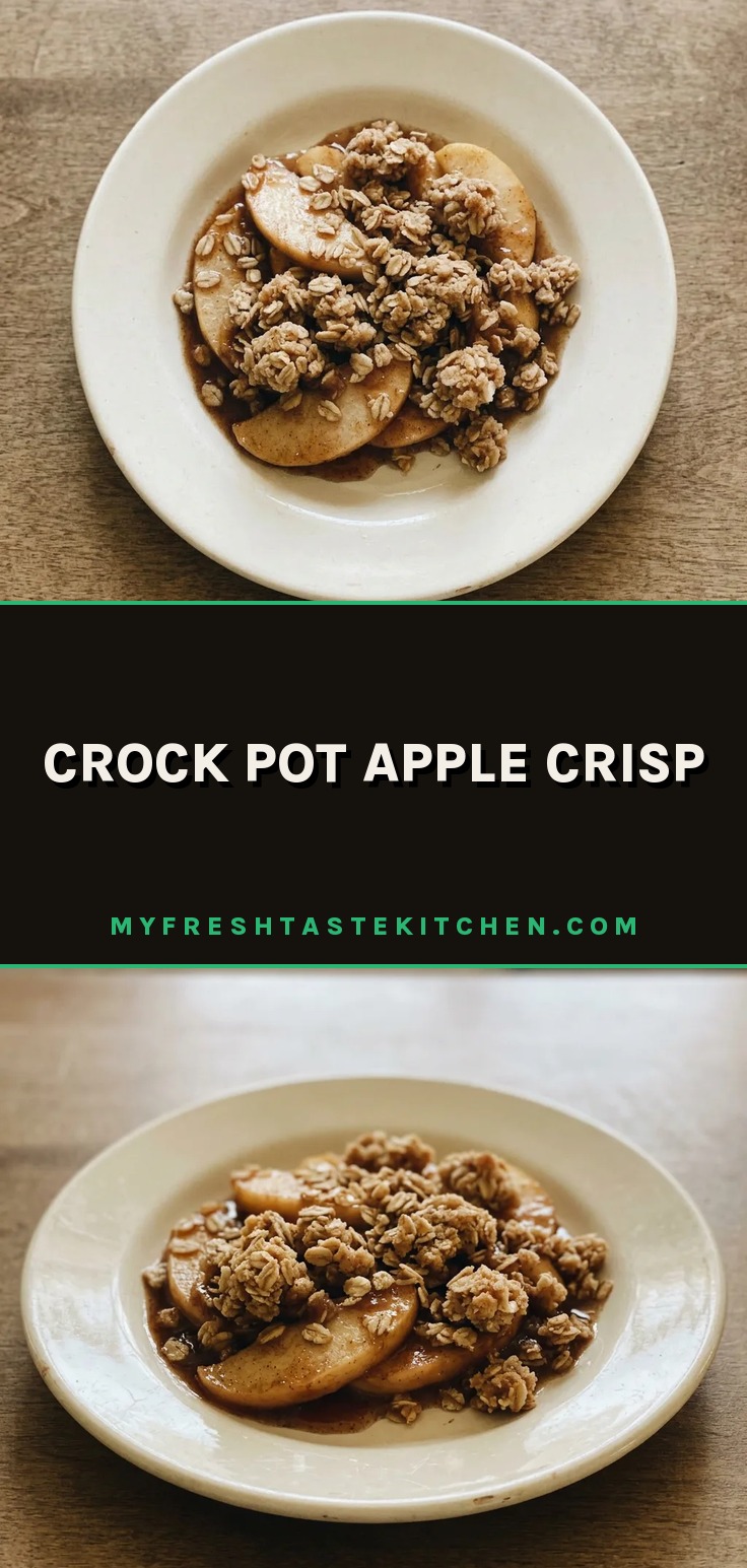 Looking down at a bowl of apple crisp with a golden oat topping and visible cinnamon specks.