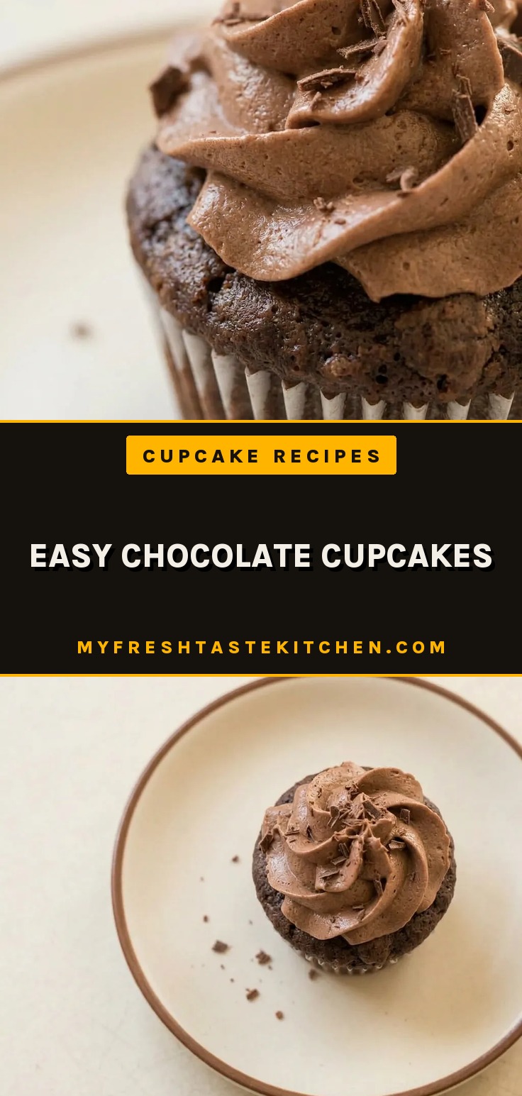 Overhead shot of three chocolate cupcakes with swirl frosting and cocoa powder dusting on a white surface.