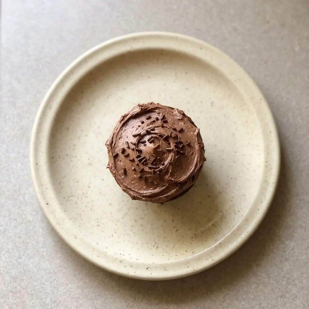 Ready to serve: a chocolate cupcake topped with swirls of chocolate buttercream.