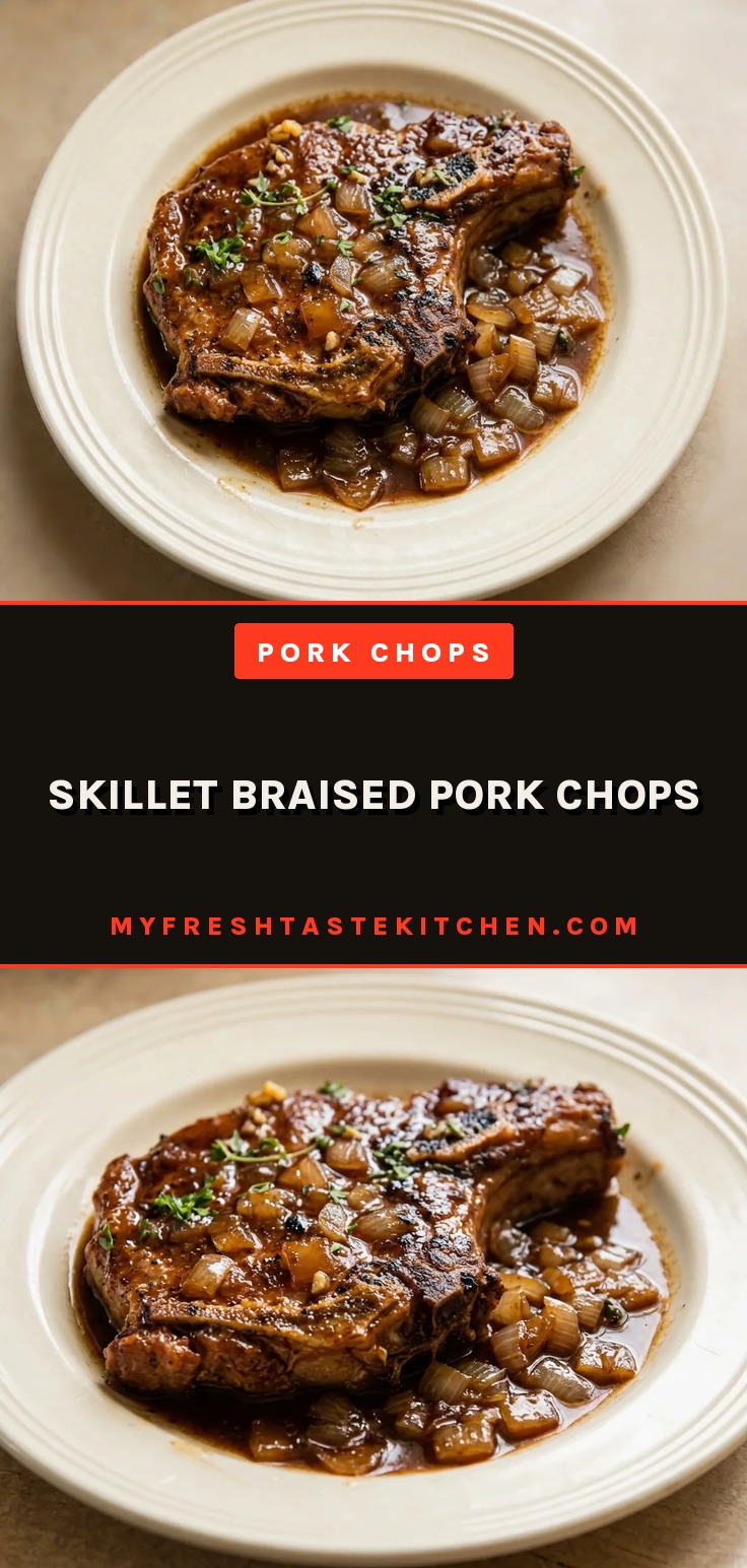 Looking down at two pork chops with balsamic glaze, topped with caramelized onions and thyme sprigs.