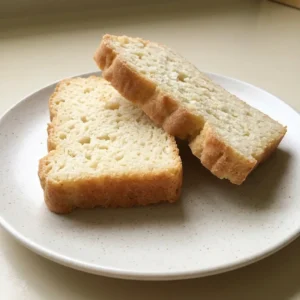Bird's-eye view of a round loaf with a golden-brown crust and a spiral score mark.