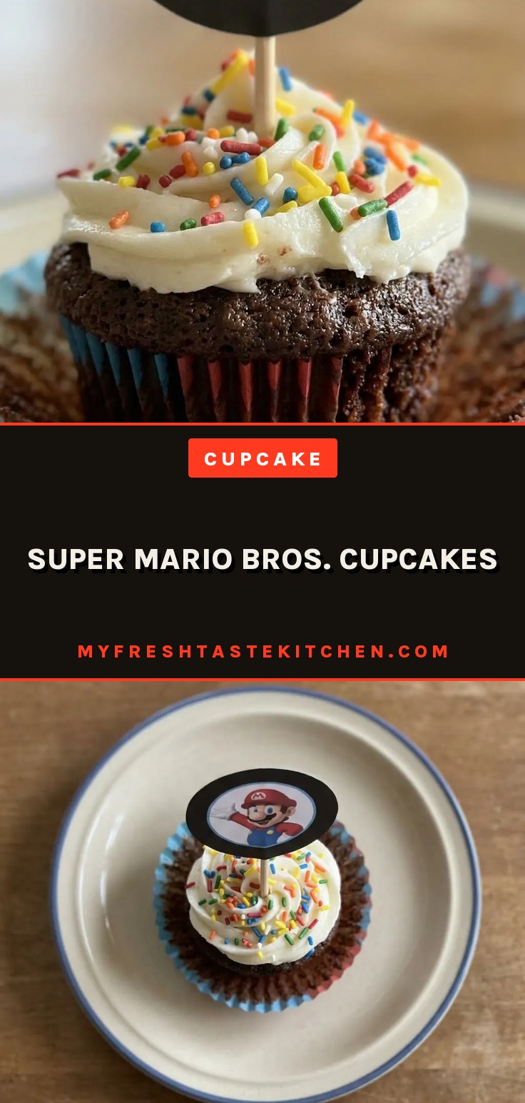 Bird's-eye view of a chocolate cupcake with vanilla frosting topped with rainbow sprinkles.
