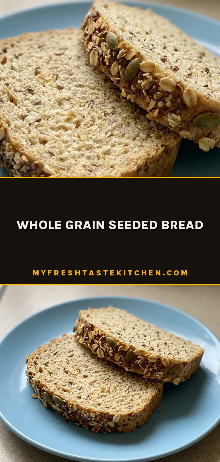 Overhead shot of a round seeded bread slice with visible oats and seed mix on the crust.