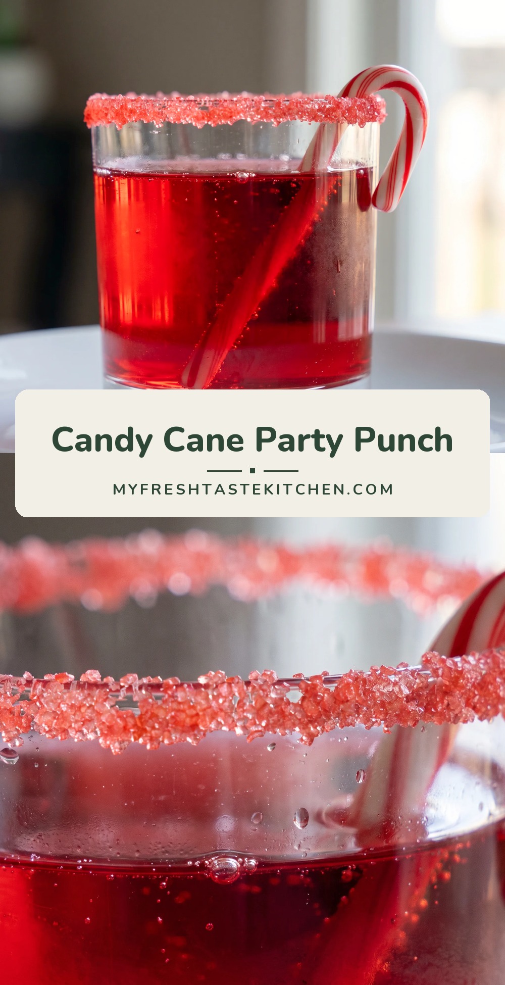 A glass of red mocktail with a candy cane garnish, surrounded by cranberries and strawberries.