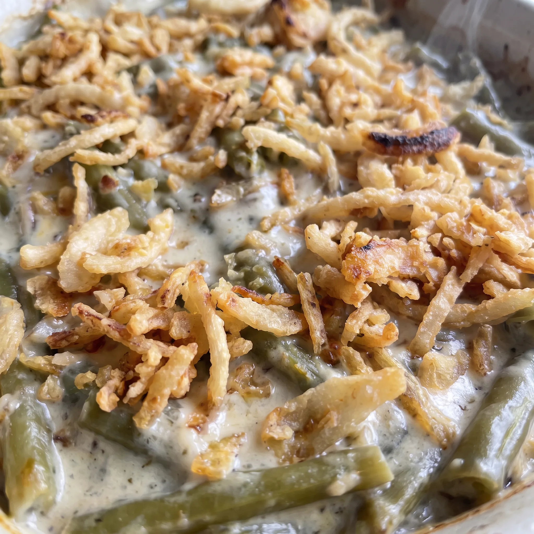 Crisp golden French fried onions over creamy mushroom sauce and tender green beans, topped with Parmesan.
