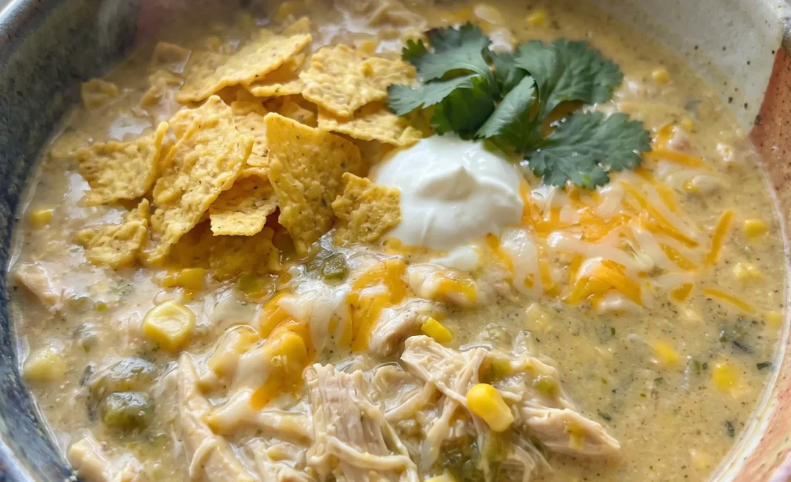 Green Chile Chicken Enchilada Soup with shredded chicken, white beans, corn, and green chiles in a creamy green sauce.