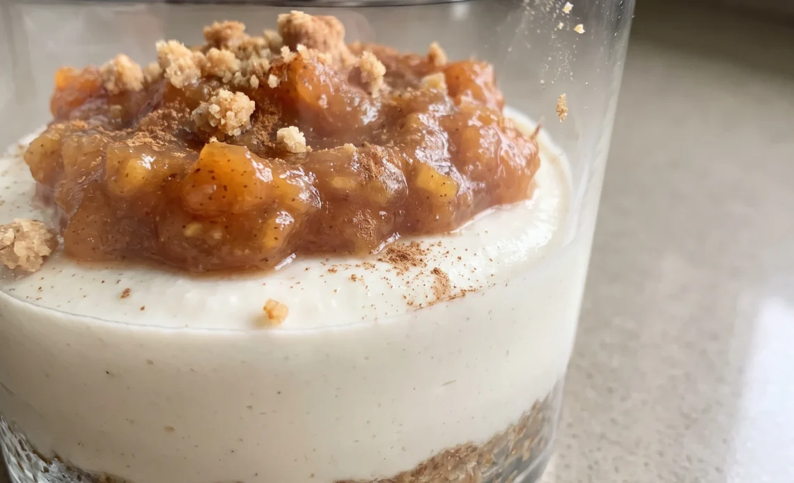 Persimmon cheesecake in a glass: layered orange persimmon puree, creamy cashew-almond filling, and date-almond crust.