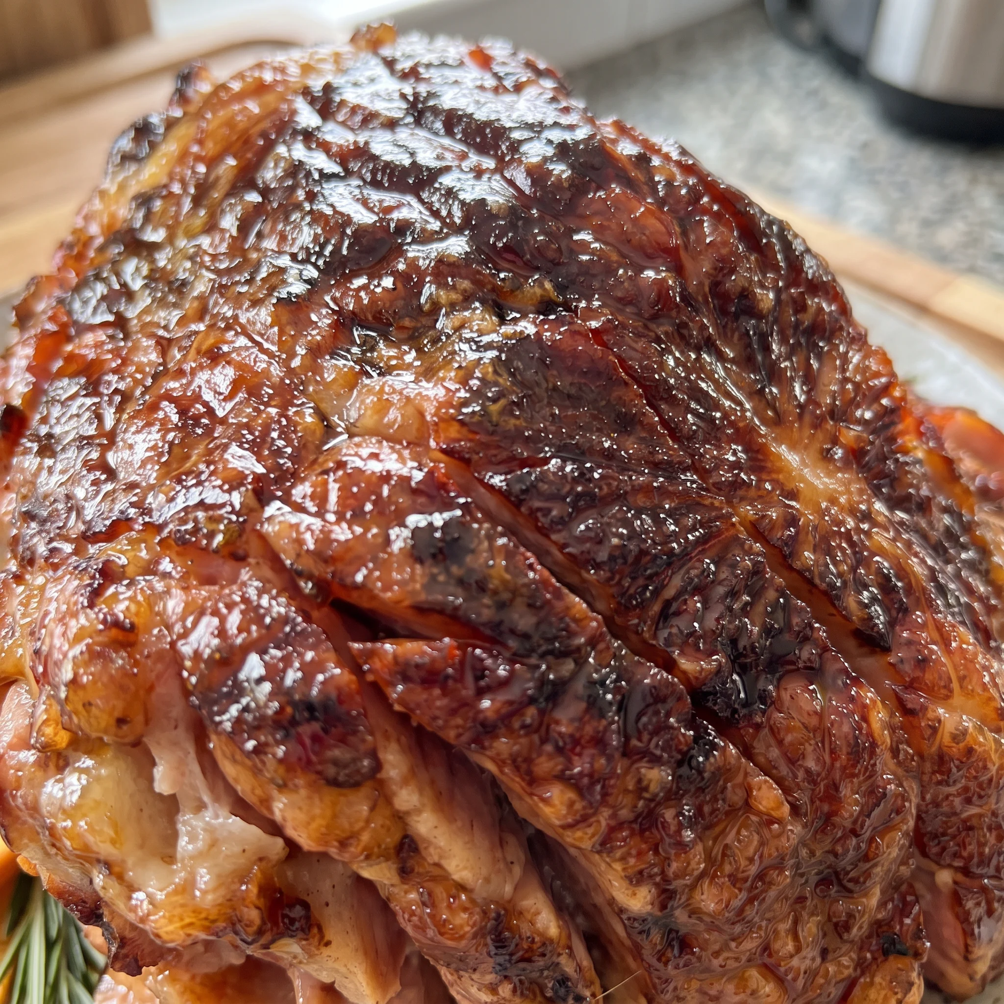 Ham slice with sticky brown sugar glaze, orange juice and mustard sauce, caramelized edges, tender texture.