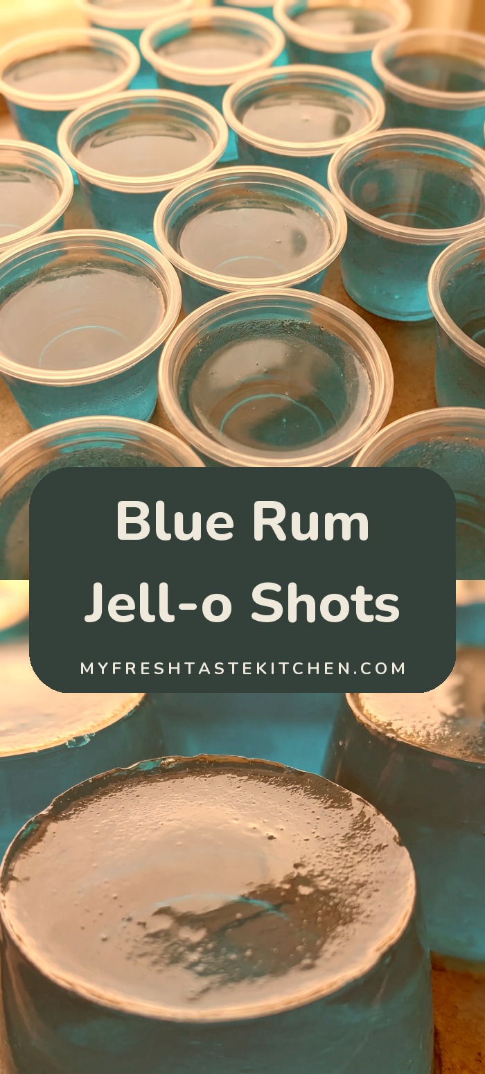 Bright blue gelatin shots in small clear plastic cups, topped with a glossy surface, made from Berry Blue Jell-O, white rum, peach schnapps, and triple sec.