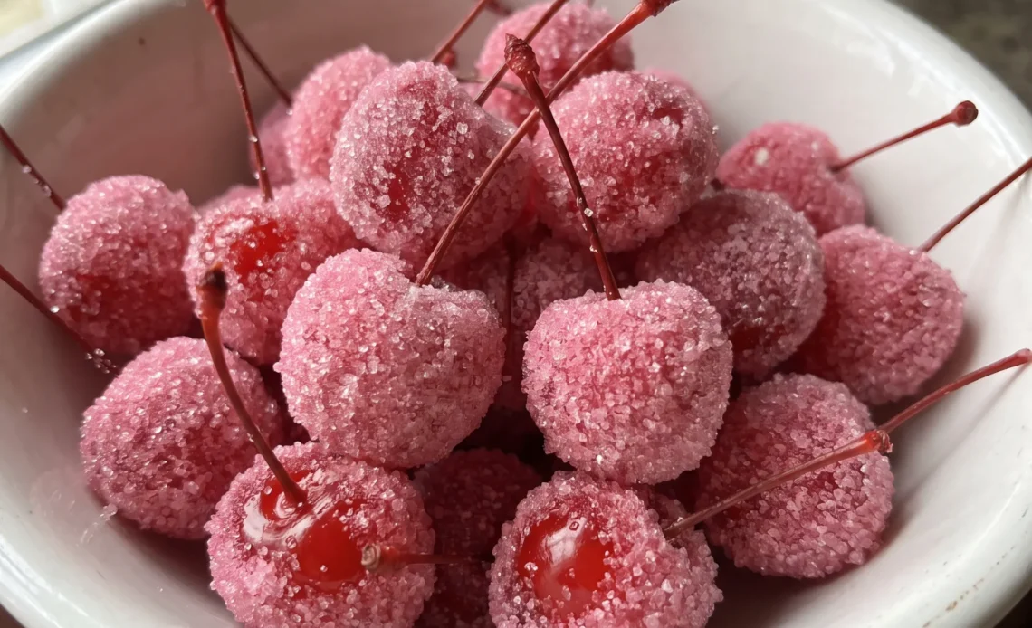 Pink Sugared Cherries: maraschino cherries fully coated in bright pink sugar, glossy red peeking through the grainy coating.