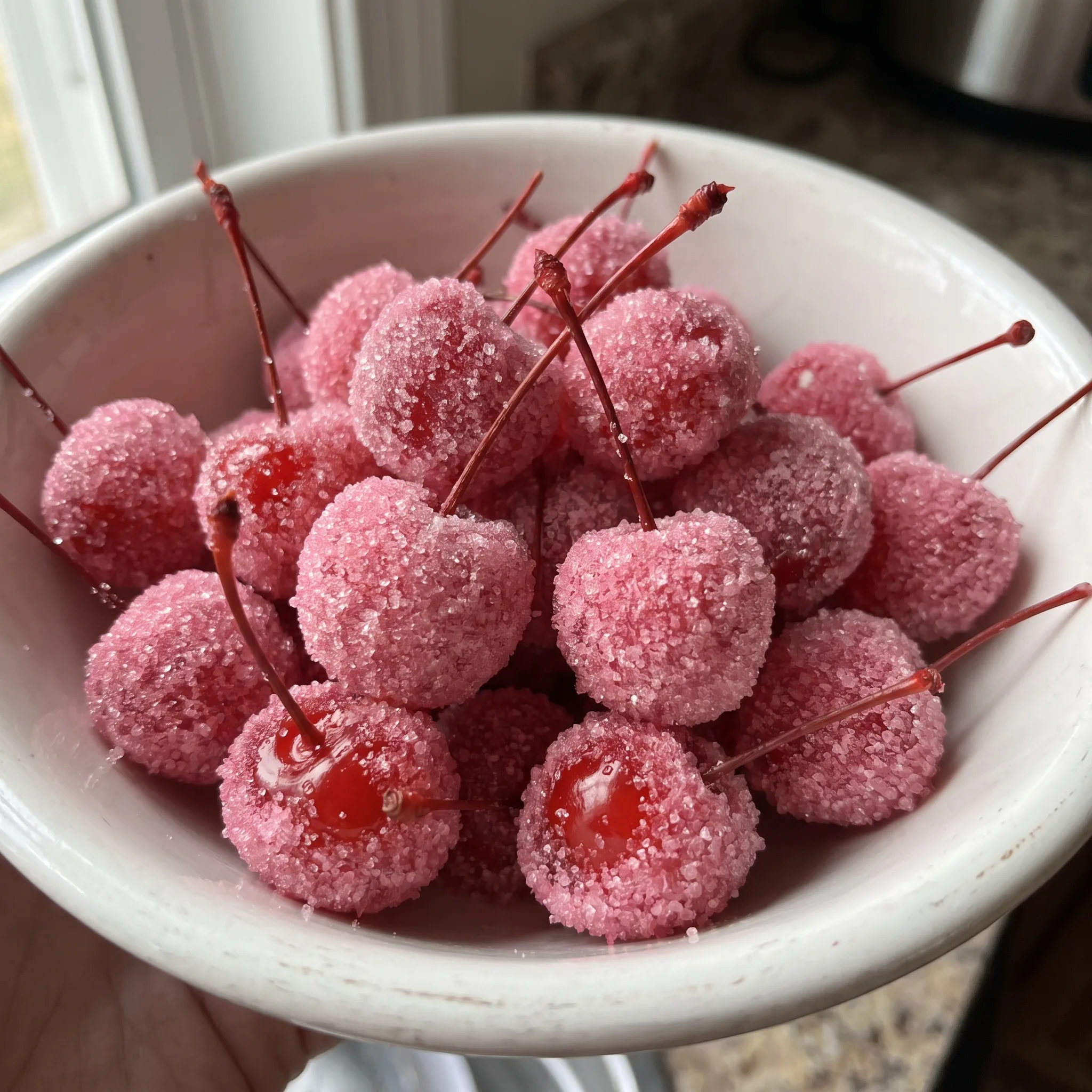 Pink Sugared Cherries: maraschino cherries fully coated in bright pink sugar, glossy red peeking through the grainy coating.