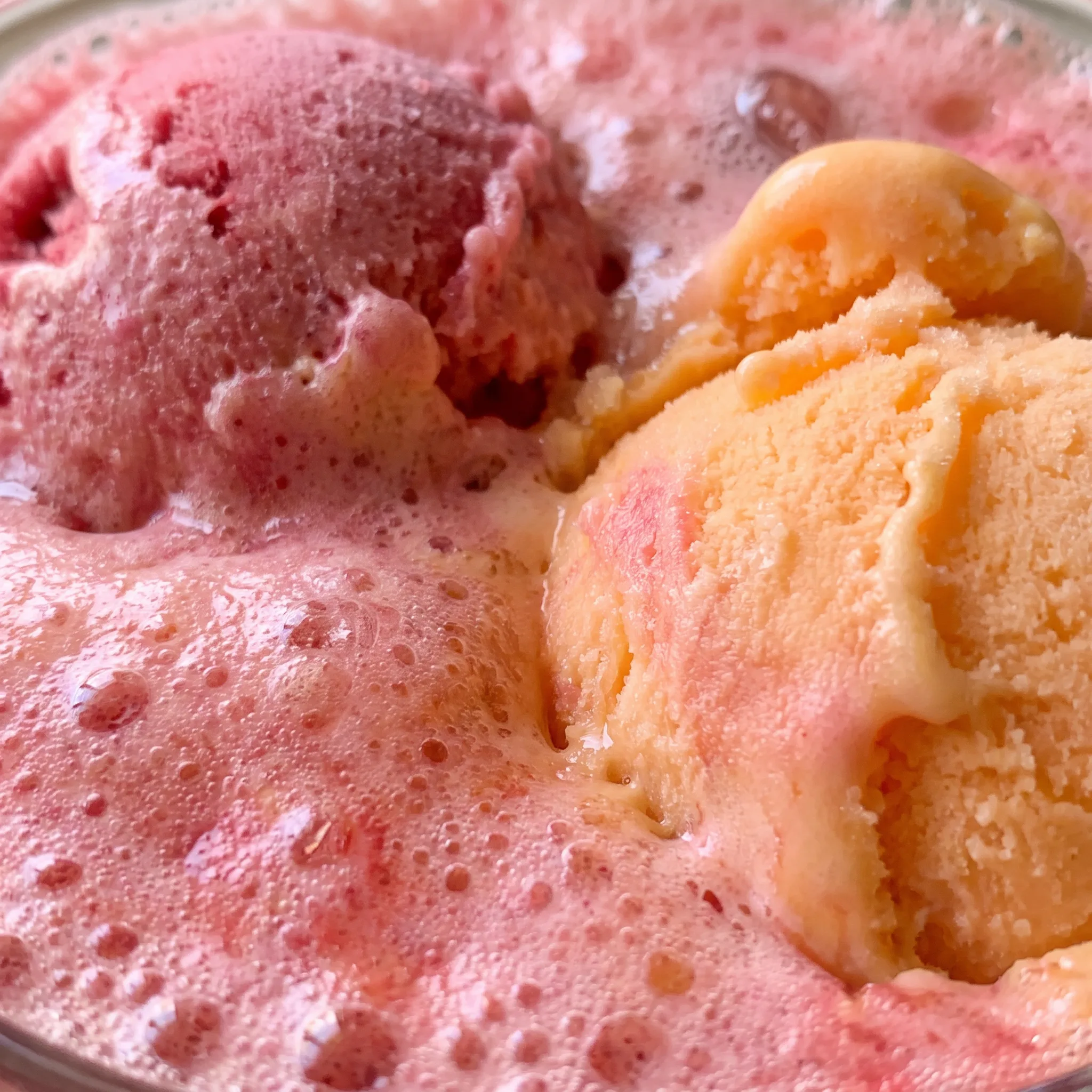 Creamy sherbet scoops dissolving in fruit punch and lemon-lime soda, pink and orange swirls, fizzy bubbles.