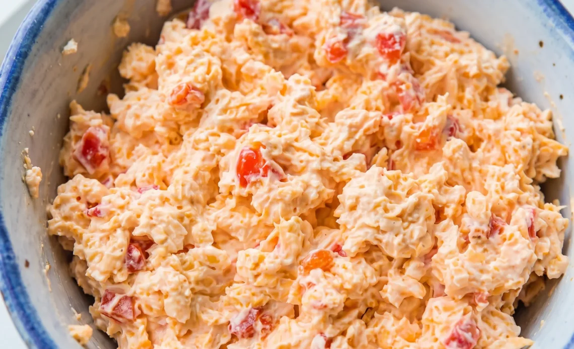 Southern pimento cheese with cream cheese, sharp cheddar, and red pimento peppers mixed into a thick, chunky spread.